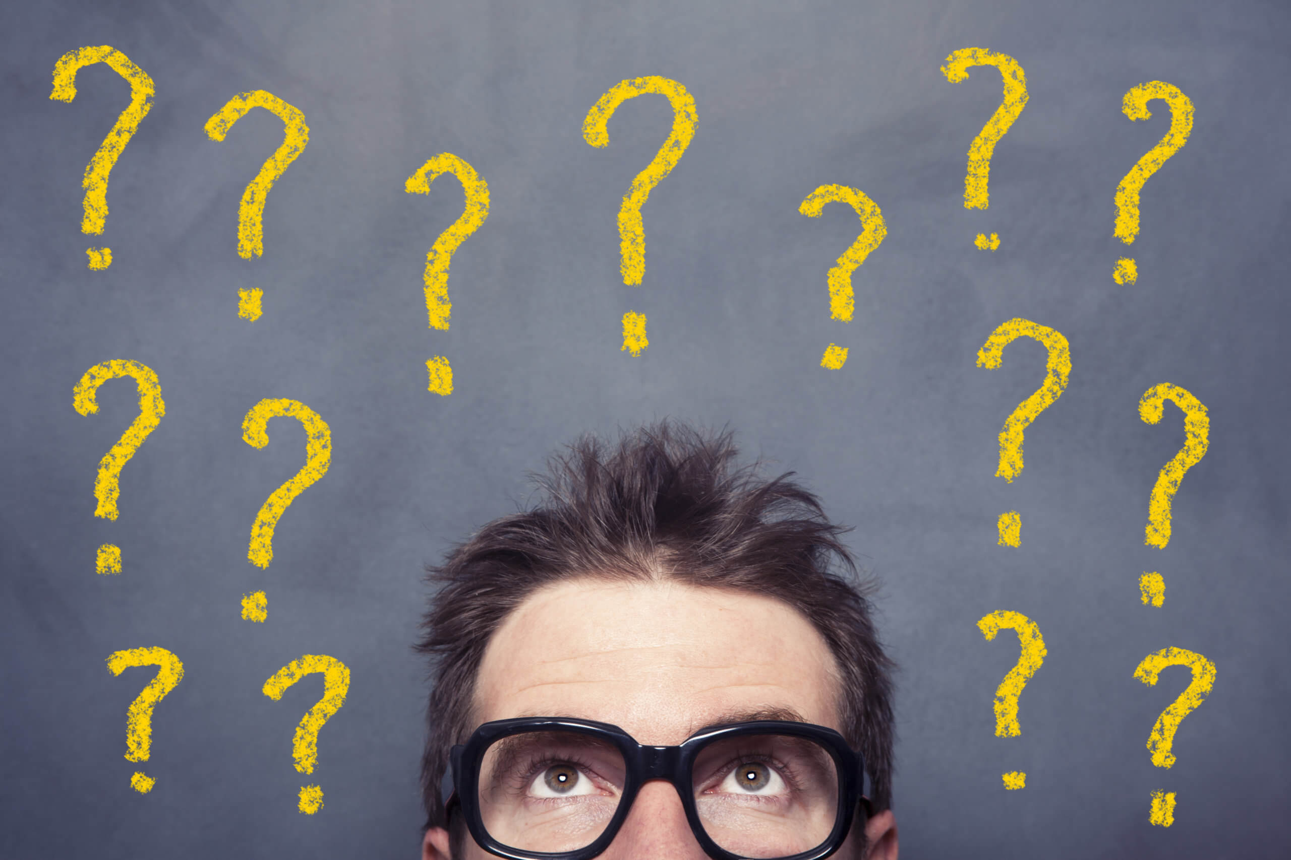 Man's head with question marks. THE FOUR STRESSFUL “UNS” – Uncertain, Unclear, Unknown, Unexpected