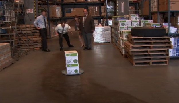 A scene from The Office featuring wooden pallets in a warehouse setting.