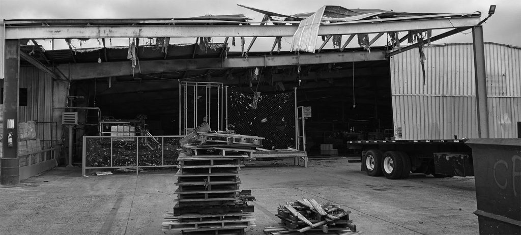 Roof damage and destroyed pallets at the PalletOne facility in New Boston, TX, following a tornado in Nov. 2022.